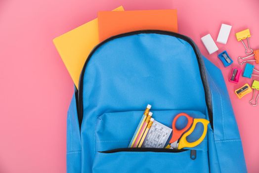 Top view flat lay of blue school bag backpack and accessories tools for children education on pink background, Back to school concept and have copy space for use
