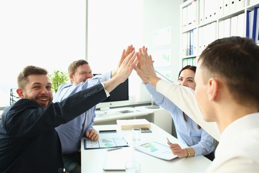 Portrait of colleagues give high five in order to celebrate successful contract, good news. Goal, success, career, new level, achievement, growth concept