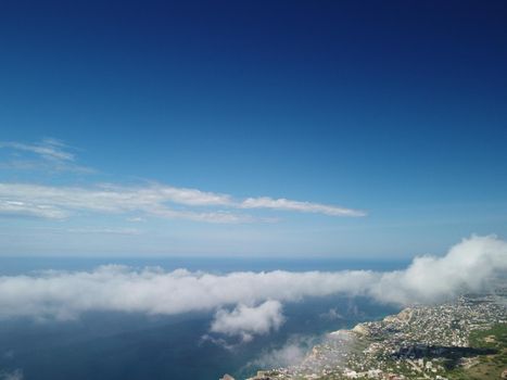 Footage B roll Aerial view drone flying above white clouds dense fog move quickly. Drone flies high back in blue sky through fluffy clouds. Beautiful foggy and cloudy slow moving Aerial view. Fog sea.