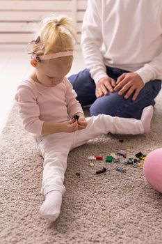 Happy child girl with cochlear implant having fun with her father - hearing aid for deaf and innovative health technology