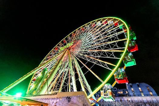 Paris, France - December 21, 2018: Ferris wheel in Christmas market in Tuileries Gardens, Paris, France