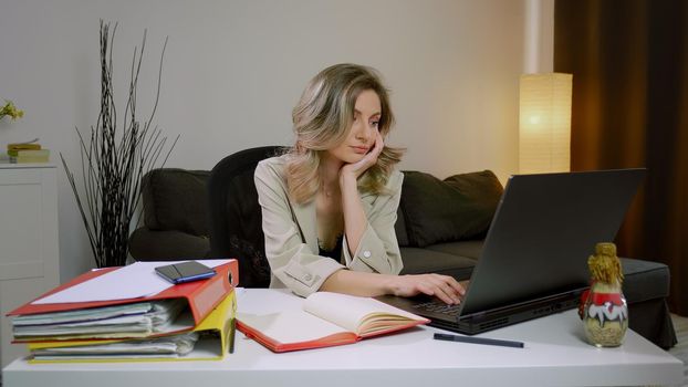 Caucasian business woman falling asleep at desk, sitting at table with laptop. Depressed unmotivated freelancer lying on table, feeling boredom working from home. Tired stressed overworked .