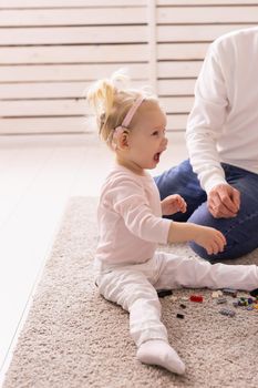 Happy child girl with cochlear implant having fun with her father - hearing aid for deaf and innovative health technology