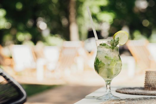 Summer Mojito Cocktail Standing on the Table of Terrace of Restaurant Outdoors, Copy Space