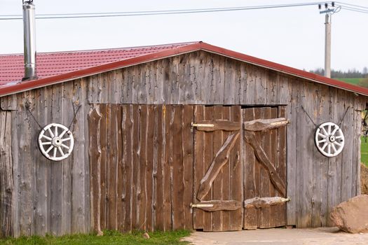 An old barn on the ranch. Large wooden gates and dried wood..