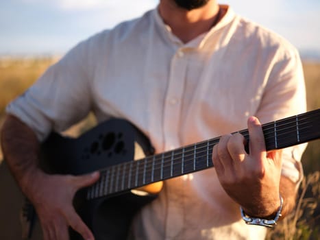 front view of a man holding an acoustic guitar, horizontal cut out picture