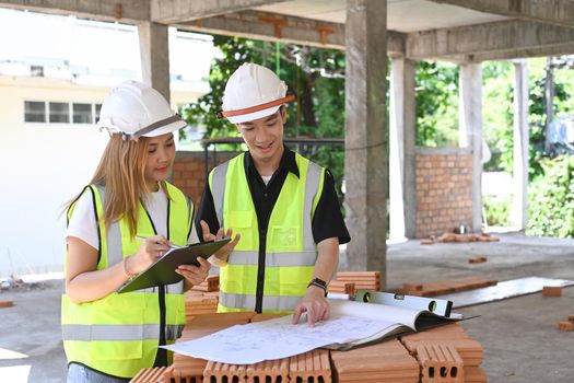 Two inspectors or engineer working and discussing about construction project together.