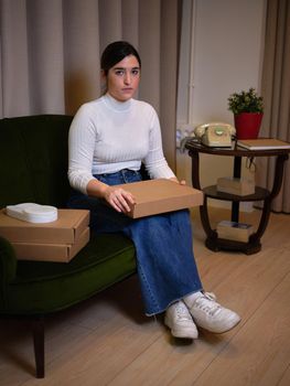 enterprising woman sitting in a vintage room showing off her new product
