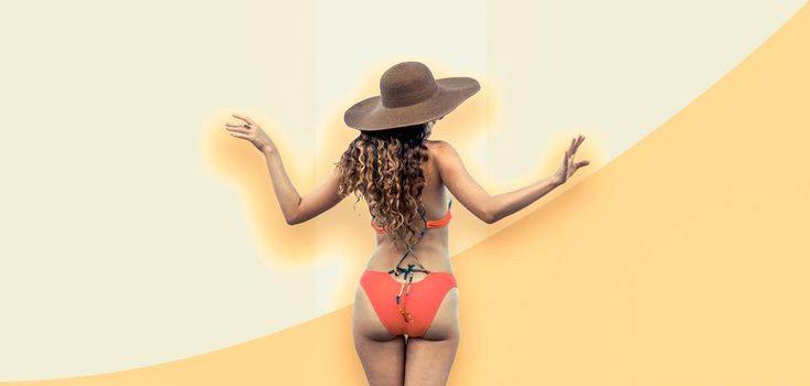 Beautiful young sexy woman in swimsuit posing on color background. Summer advertising.