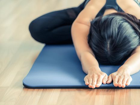 Woman practicing yoga pose in gym, close up view. Healthy lifestyle and wellness concept.