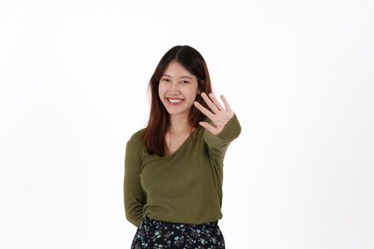 Image of happy young girl standing and Looking camera pointing isolated over white background