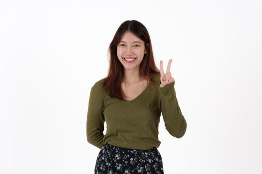 Image of happy young girl standing and Looking camera pointing isolated over white background