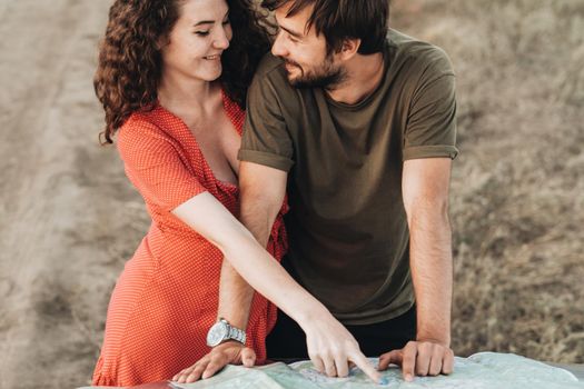 Happy Young Couple, Cheerful Man and Woman Checking Map to Plan Their Next Road Trip