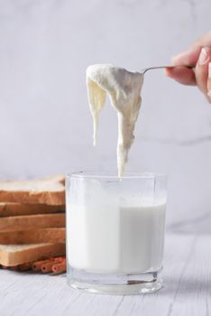 glass of whole cream milk on table ,