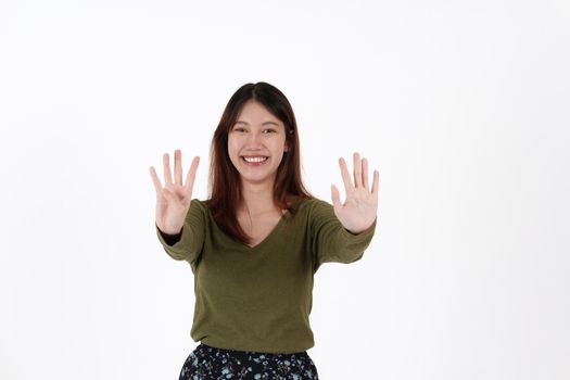 Image of happy young girl standing and Looking camera pointing isolated over white background