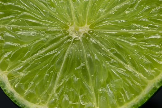 Green lime citruss fruit cutting half macro fiber inside