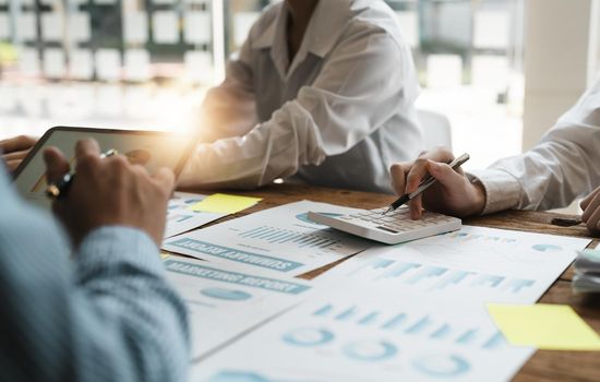 Business people analyzing investment graph meeting brainstorming and discussing plan in meeting room, investment concept.