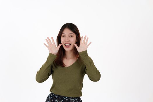 Image of happy young girl standing and Looking camera pointing isolated over white background