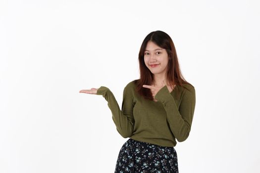 Image of happy young girl standing and Looking camera pointing isolated over white background