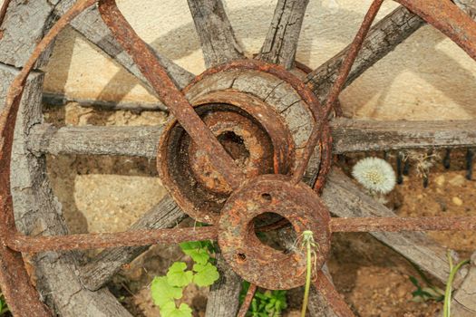 Old rusted wood and metal cart wheel