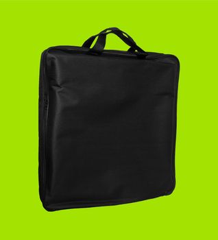 a simple bag made of material, black, for a laptop on a light green background