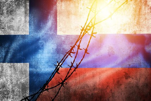 Grunge flags of Russian Federation and Finland divided by barb wire sun haze illustration, concept of tense relations between west and Russia