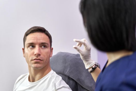 Doctor explaining to a patient while gesturing at a unit of measure in a clinic