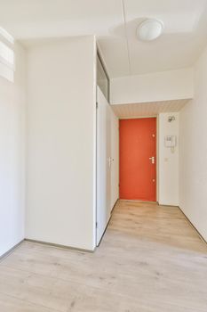 Interior of modern flat in minimal style with narrow empty corridor illuminated by lamps