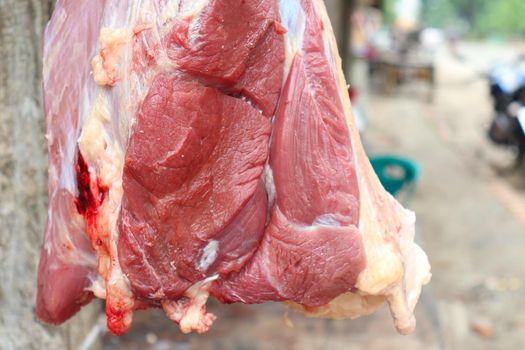 red colored beef closeup with hanging on shop for sell