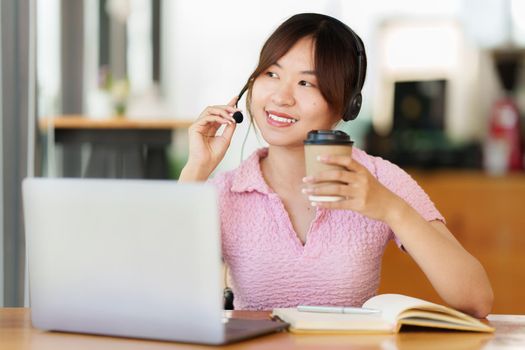 E-learning Online Education concept. Asian woman attentive student student video conference e-learning with teacher on laptop computer at home