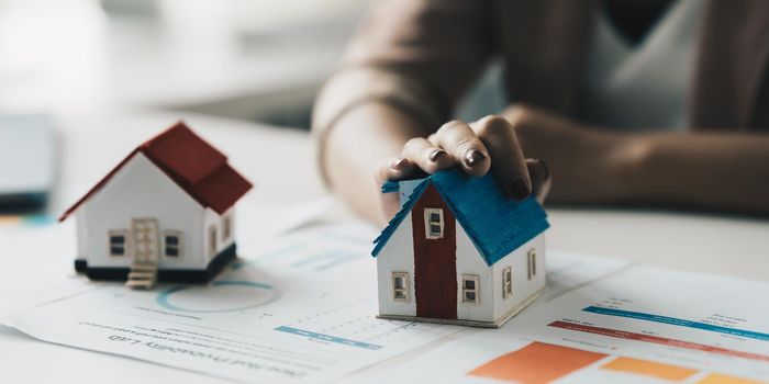 Close up of Business woman choosing house after signing agreement for buying house. Bank manager concept