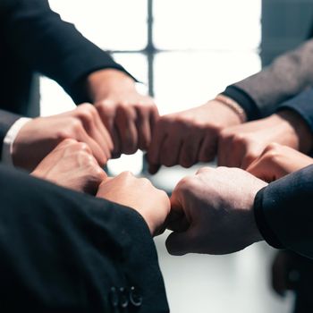 close up . ambitious business team standing in a circle. the concept of teamwork