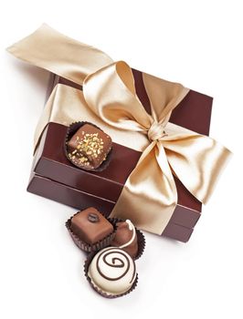 brown box with candies and golden tape isolated on the white