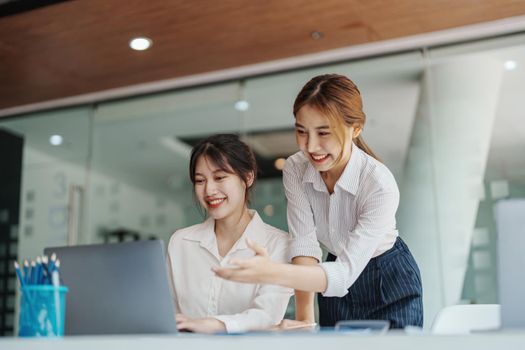 financial, Planning, Marketing and Accounting, portrait of Asian woman Economist using computer and investment documents with partners on profit taking to compete with other companies.