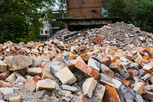 Piles of old red bricks and stones from ruins of old buildings