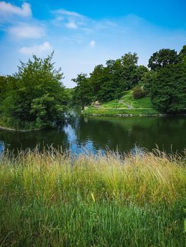 Colorful landscape of city moat and hills around full of trees and bushes