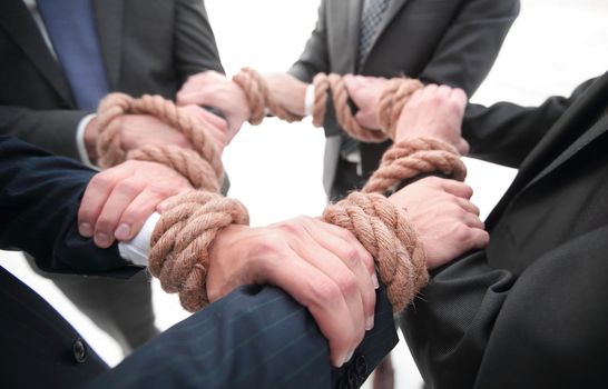 closeup.Hands holding rope forming a circle.the concept of teamwork