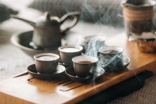 Cups with poured tea before the tea ceremony with incense.