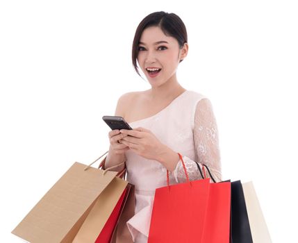 woman using smartphone and holding shopping bags isolated on a white background