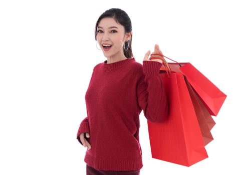 cheerful woman holding red shopping bag isolated on a white background