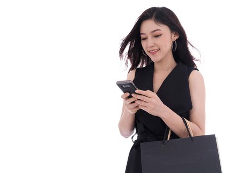 woman using smartphone and holding shopping bags isolated on a white background