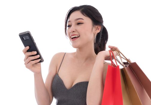 woman using smartphone and holding shopping bags isolated on a white background