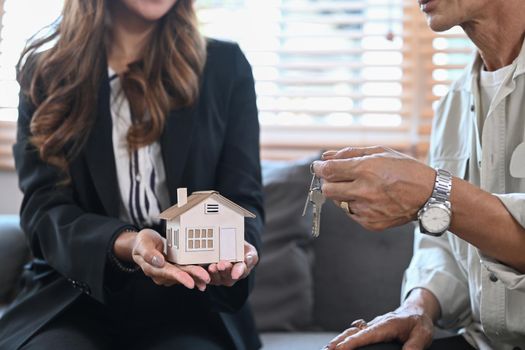 Cropped image of senior owners making sale purchase property with real estate agent.