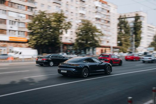 Ukraine, Kyiv - 16 July 2021: Black Porsche car moving on the street. Editorial