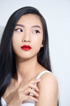 Beauty portrait of Asian female beauty model isolated on white background. Closeup of woman with long dark hair.