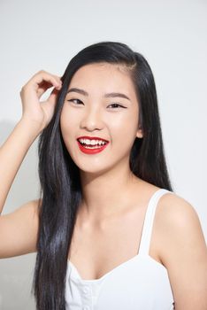 Beauty portrait of Asian female beauty model isolated on white background. Closeup of woman with long dark hair.