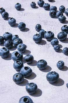 Fresh blueberries on rustic concrete table. Healthy organic seasonal fruit background. Organic food blueberries and mint leaf for healthy lifestyle. Healthy eating