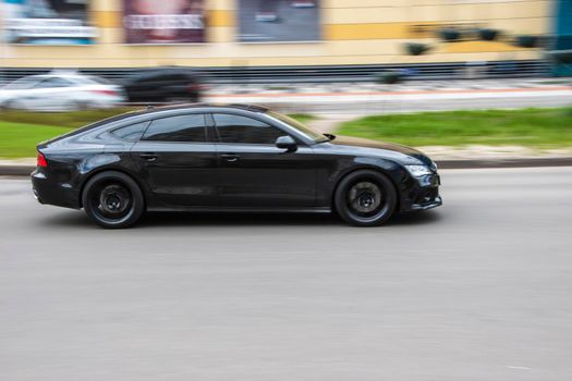 Ukraine, Kyiv - 26 April 2021: Black Audi A7 car moving on the street. Editorial