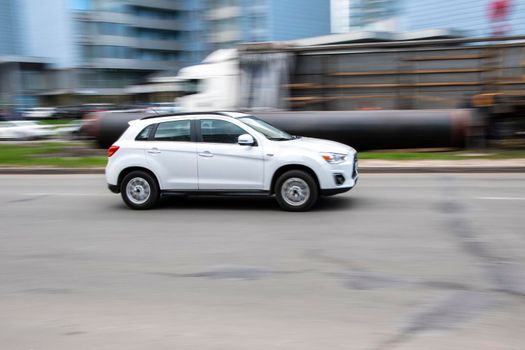 Ukraine, Kyiv - 26 April 2021: White Mitsubishi ASX car moving on the street. Editorial