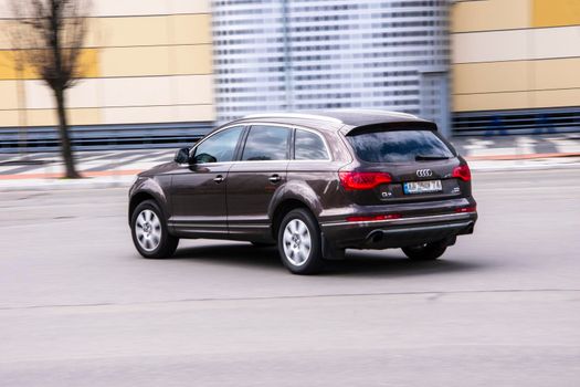 Ukraine, Kyiv - 26 April 2021: Brown Audi Q7 car moving on the street. Editorial